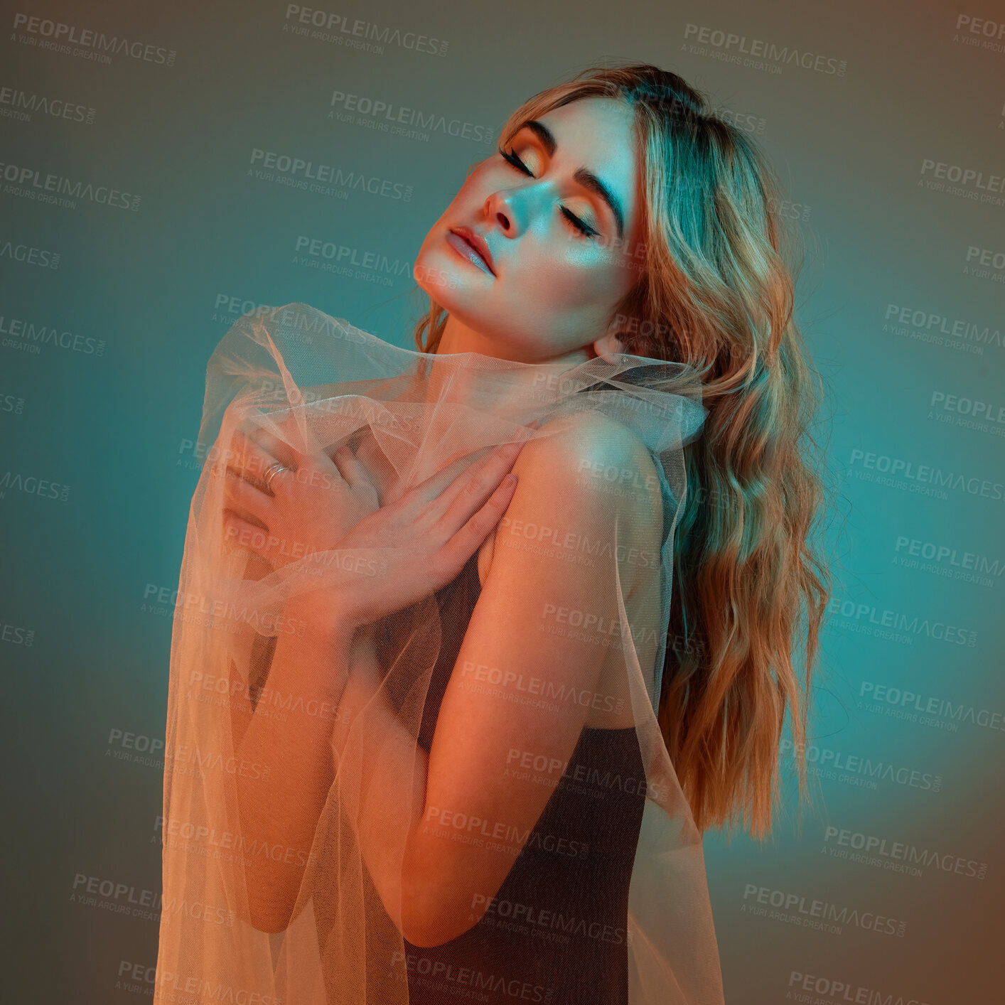 Buy stock photo Fashion, silk and woman with fabric in neon studio for elegance, style or eyes closed isolated on blue background. Self love, hug and model with clothes for body, creative glamour or makeup cosmetics