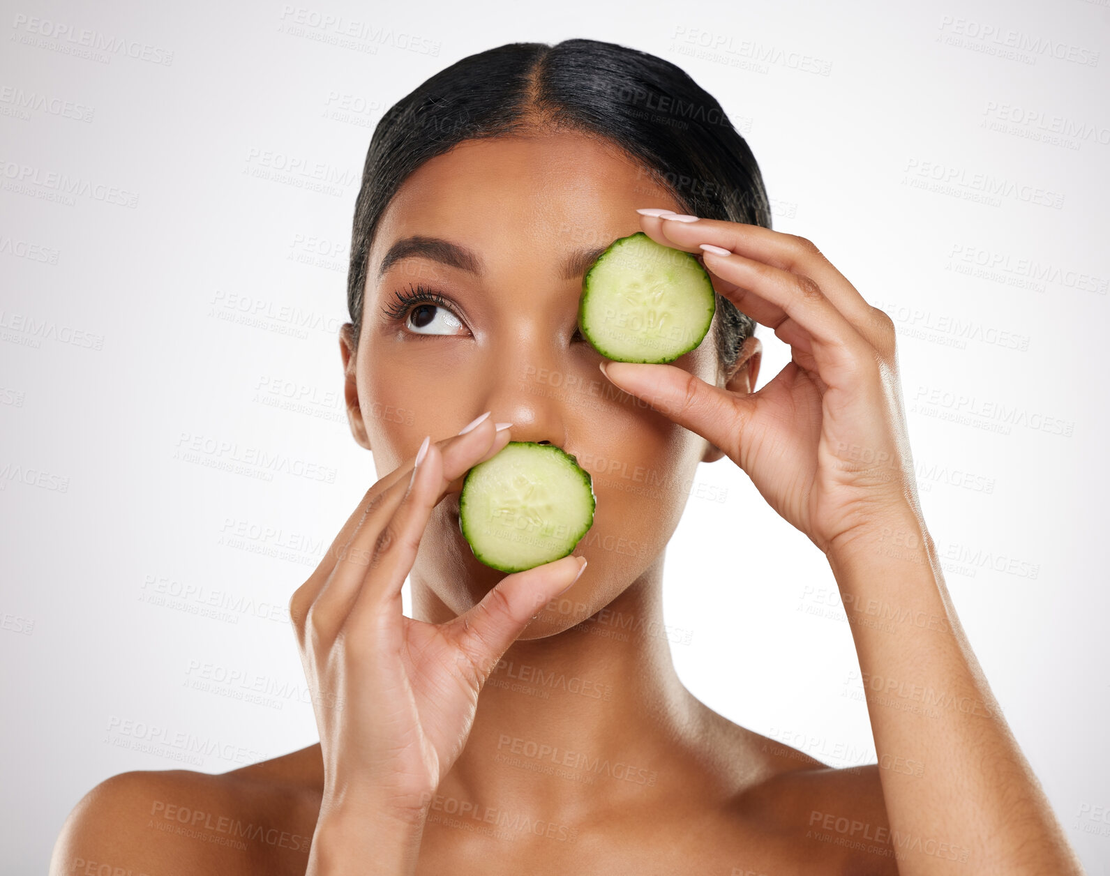 Buy stock photo Studio shot of an attractive young woman posing with two slices of cucumeber against a grey background