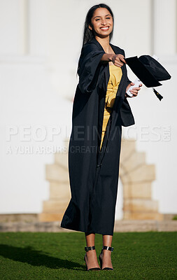 Buy stock photo Shot of a young woman tossing her hat into the air on graduation day