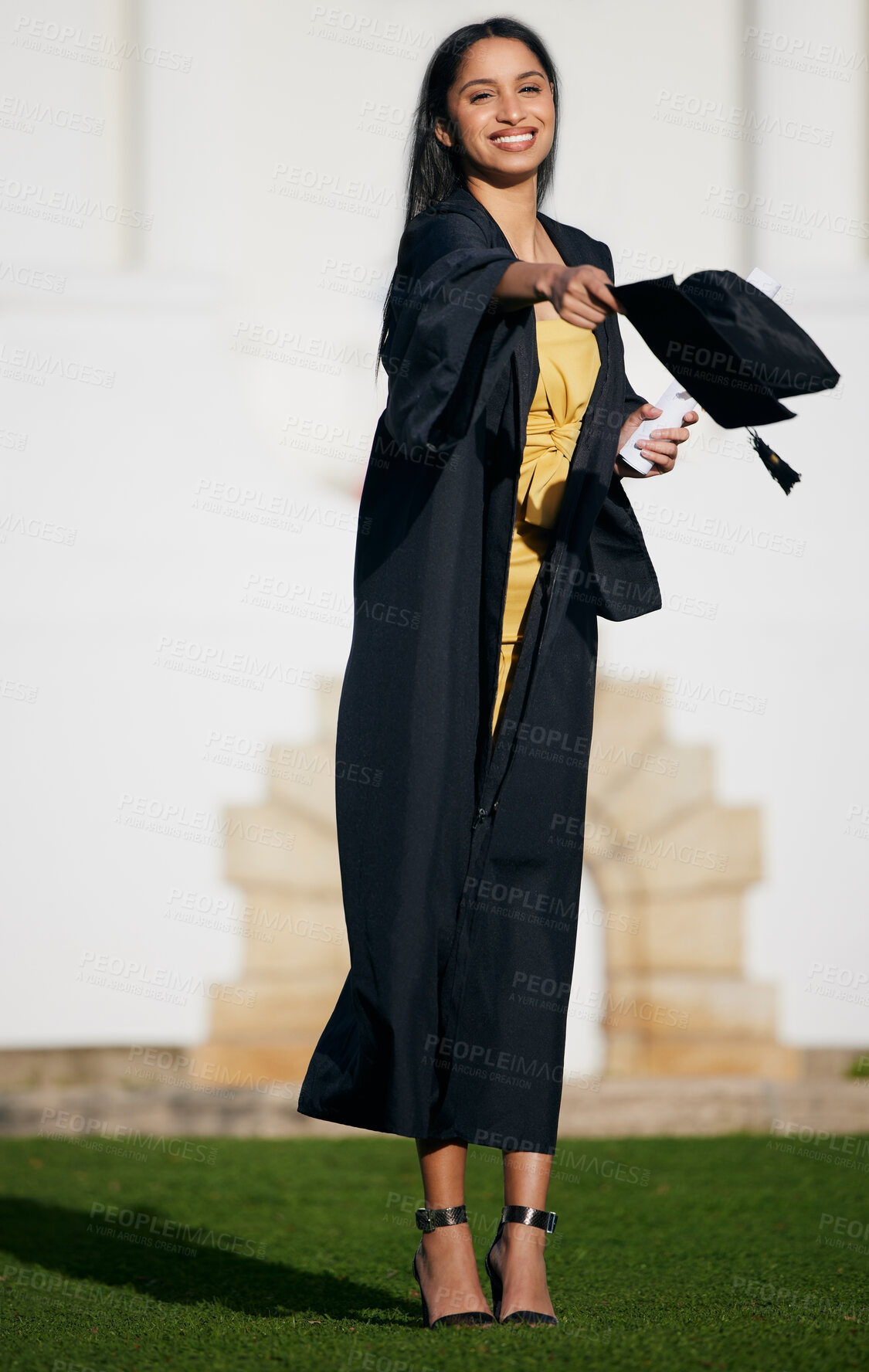 Buy stock photo Shot of a young woman tossing her hat into the air on graduation day