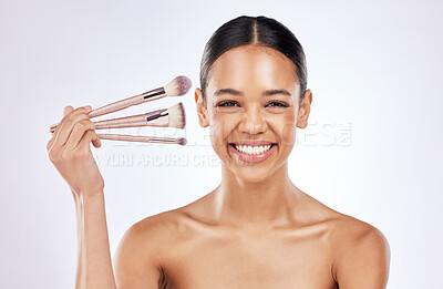 Buy stock photo Studio portrait, cosmetics and happy woman with brushes for foundation with skin transformation and makeup results. Girl, skincare and beauty tools for facial glow and wellness by white background