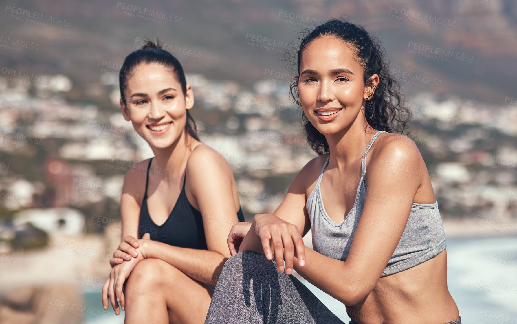 Buy stock photo Shot of two young friends taking a break during a workout