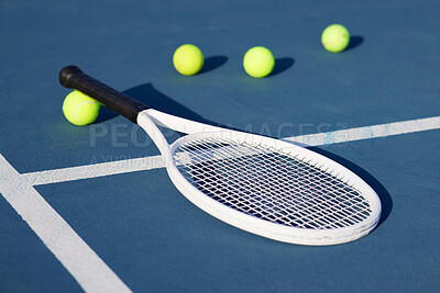 Buy stock photo Shot of a tennis rackets and tennis balls on a court during the day