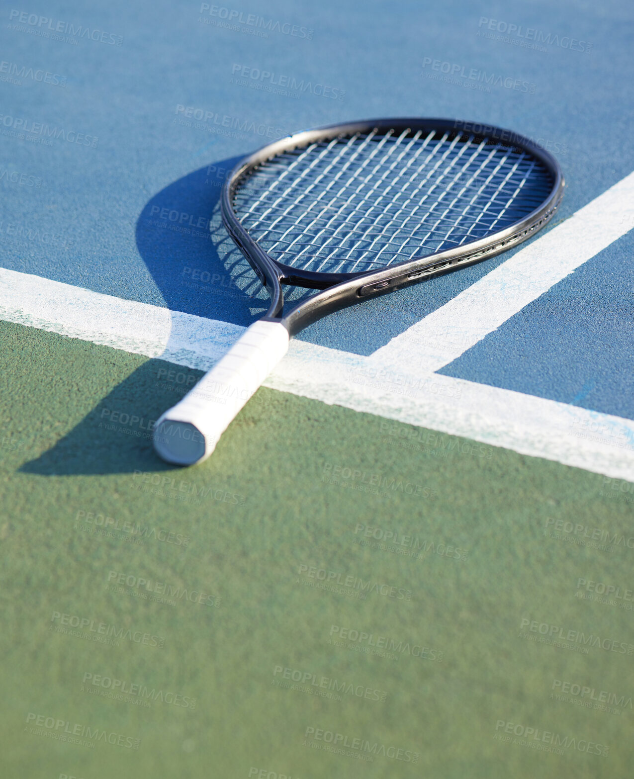 Buy stock photo Shot of a tennis racket on a court during the day