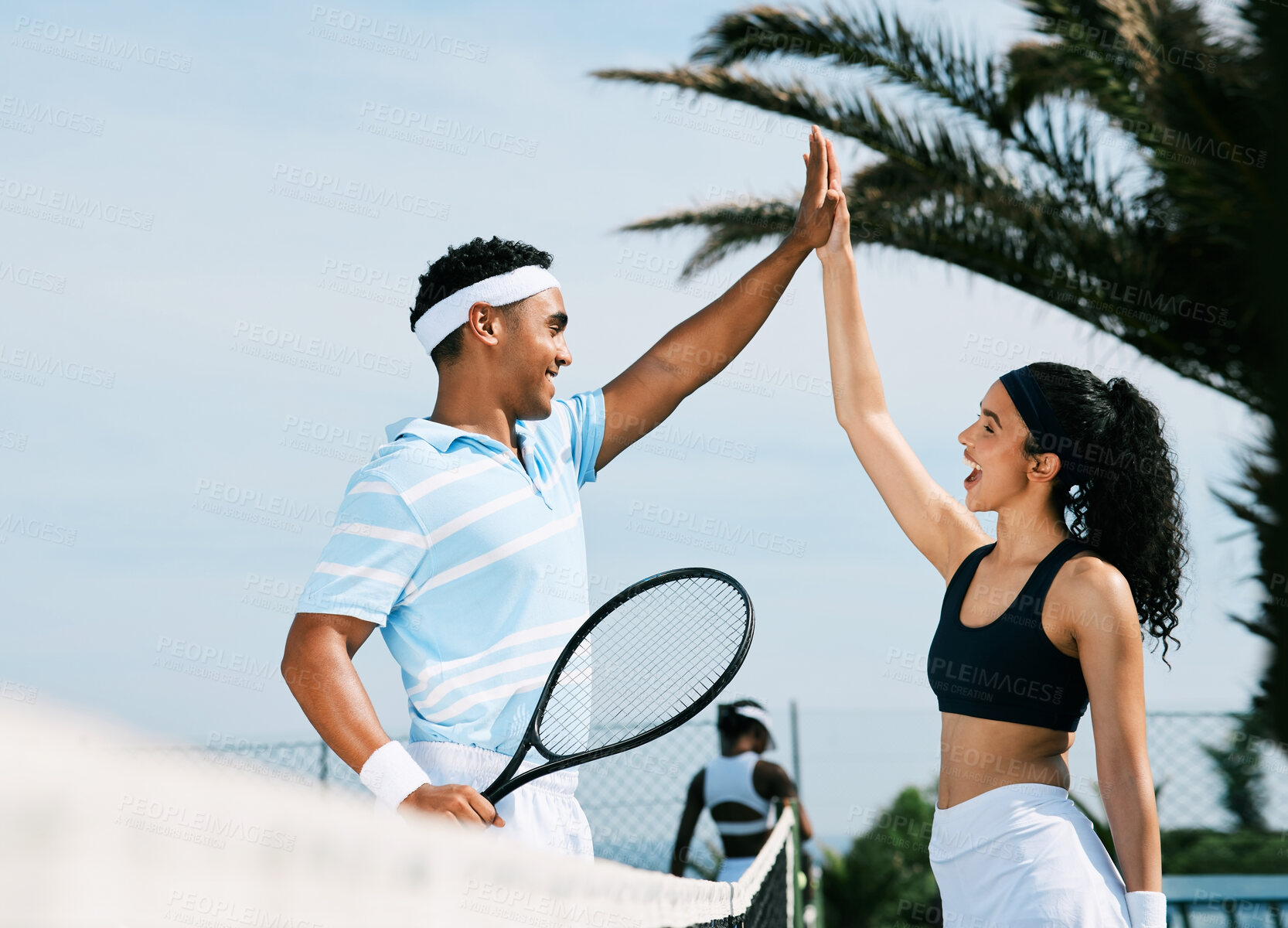 Buy stock photo Shot of tennis teammates sharing a high five during a tennis match