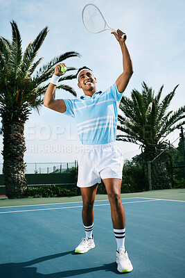 Buy stock photo Shot of a handsome young man getting ready to serve a ball during a tennis match