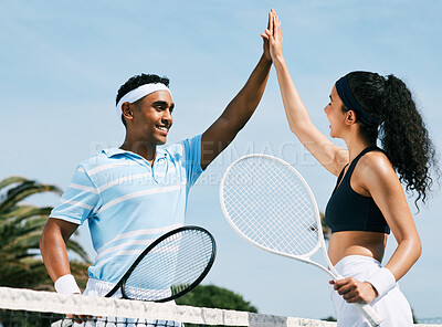 Buy stock photo Shot of tennis teammates sharing a high five during a tennis match