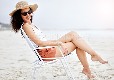 Buy stock photo Shot of a young woman enjoying a day at the beach