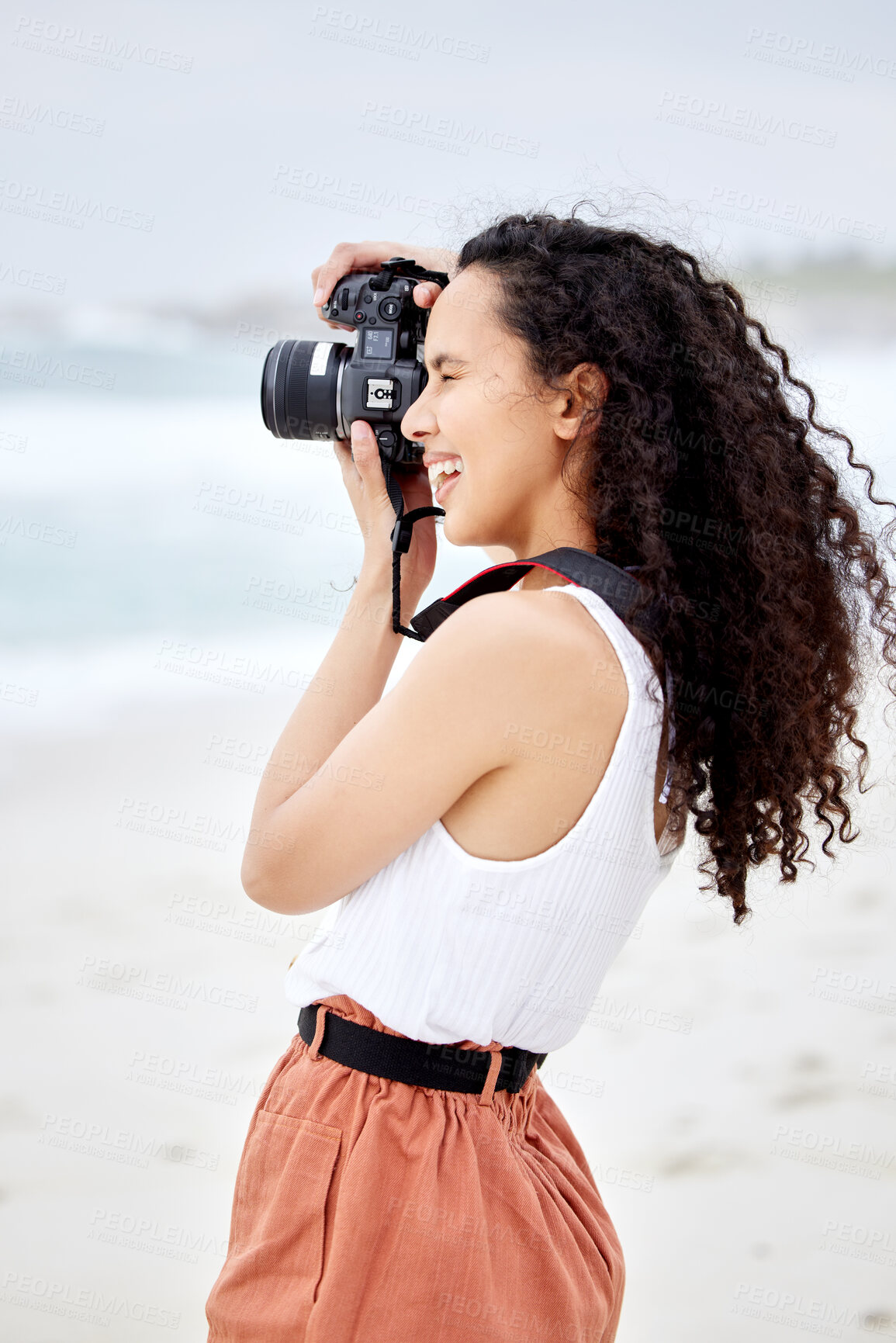 Buy stock photo Beach, outdoor and woman with camera for photography, nature scenery and vacation travel with happy memory. Girl, ocean and photographer with DSLR lens for cinematic shot and sea picture in Australia