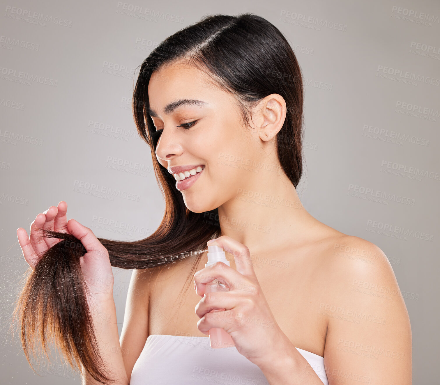 Buy stock photo Happy, woman and hands for haircare with spray or keratin serum for growth and product placement . Female person or model and smooth texture from luxury treatment for healthy natural hair in studio