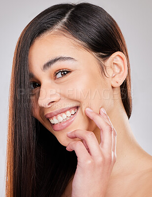 Buy stock photo Studio shot of a woman with beautiful brown hair posing against a grey background