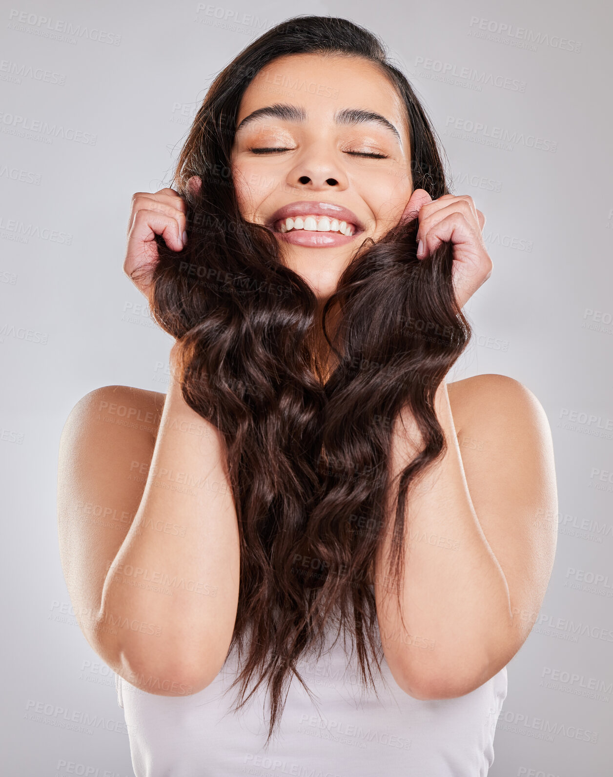 Buy stock photo Haircare, growth and strong in studio, woman and shine with treatment from salon, happy and texture. White background, smile and hands with hair, hairstyle and person with cosmetics of shampoo