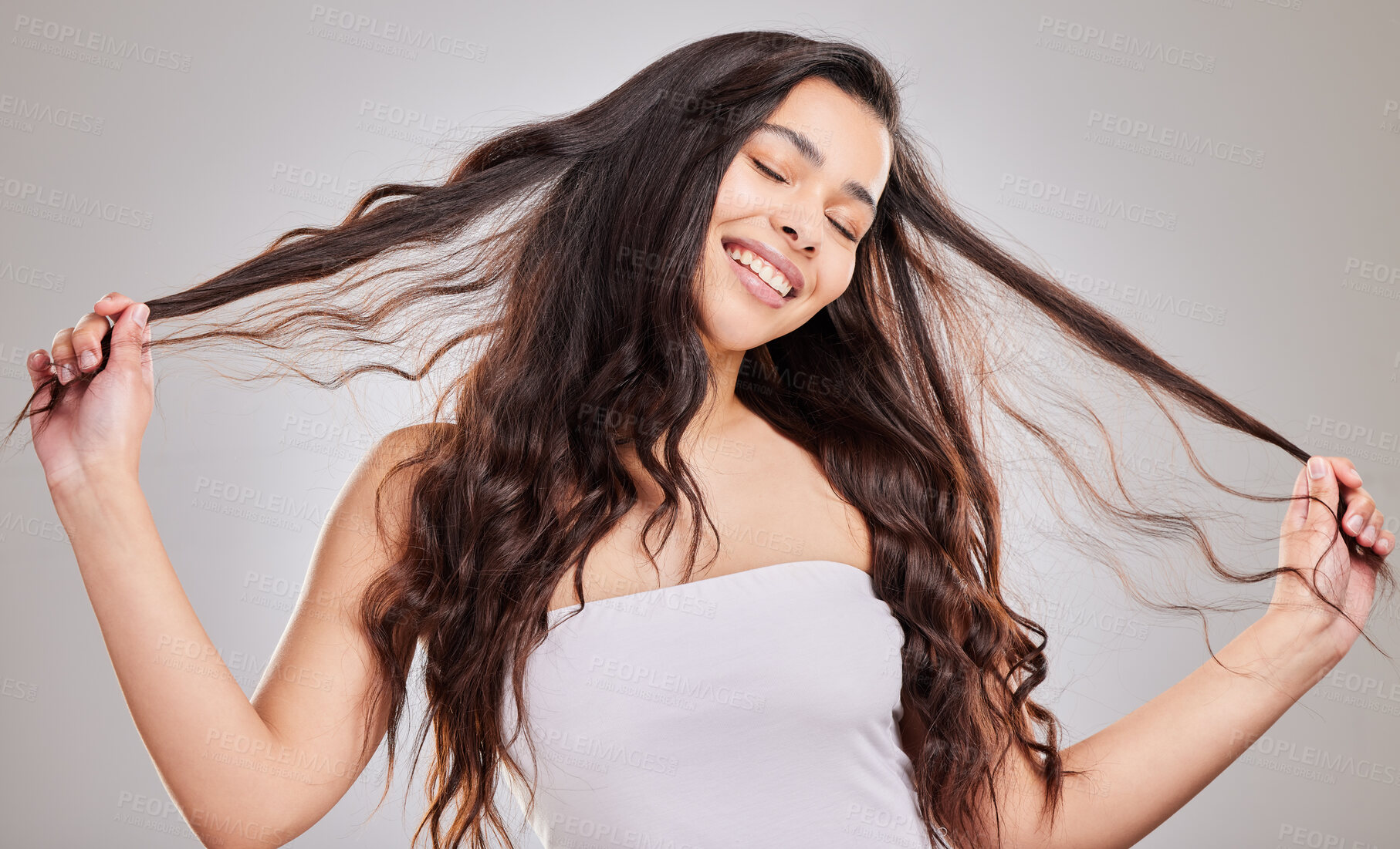 Buy stock photo Curls, woman and hair strand with haircare in studio for salon treatment, hairstyle or shampoo on white background. Texture, cosmetics and happy model for growth, satisfaction and natural glow