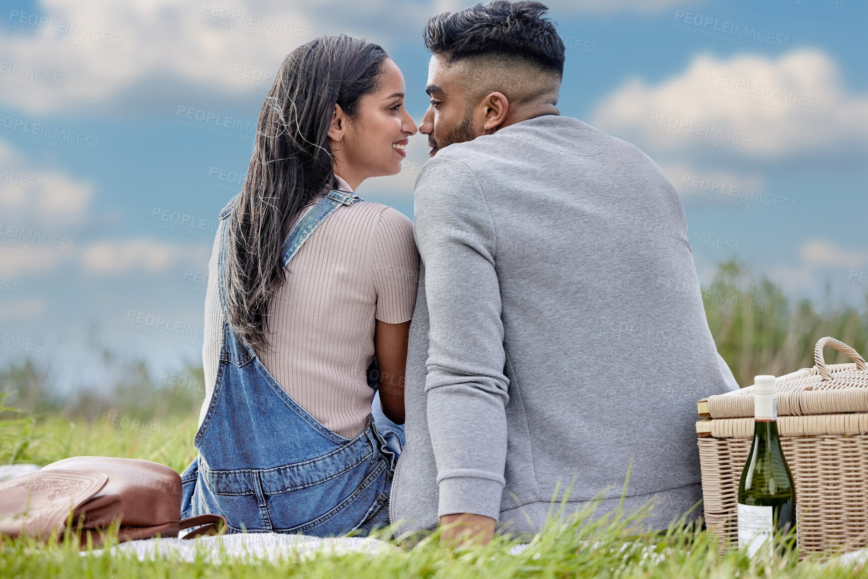Buy stock photo Man, woman and love in nature for date, picnic and wine for relax in field. Couple, affection and romantic in park for celebration, anniversary and vacation or travel to countryside together