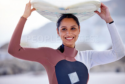 Buy stock photo Girl, outdoor and surfboard on head at beach, workout and training for water sports competition. Female person, health and travel to ocean or sea for wave, fitness and athlete for exercise in nature