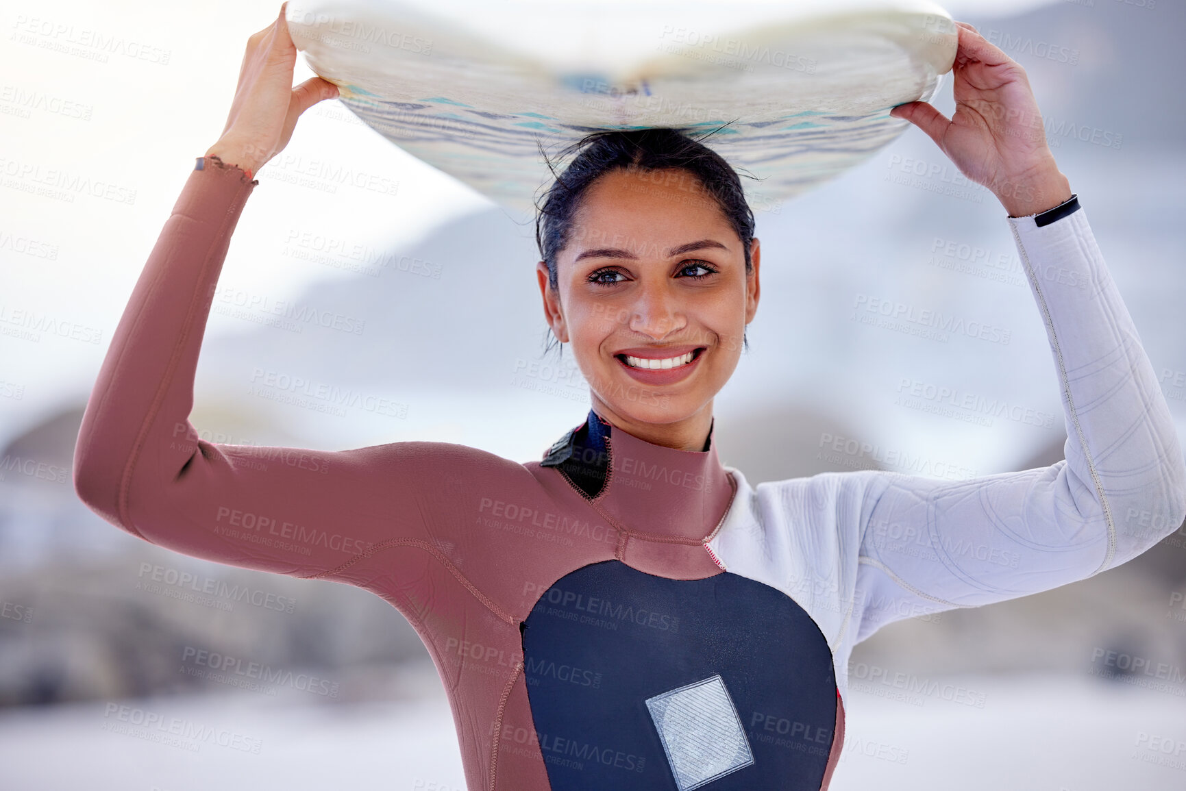 Buy stock photo Girl, outdoor and surfboard on head at beach, workout and training for water sports competition. Female person, health and travel to ocean or sea for wave, fitness and athlete for exercise in nature