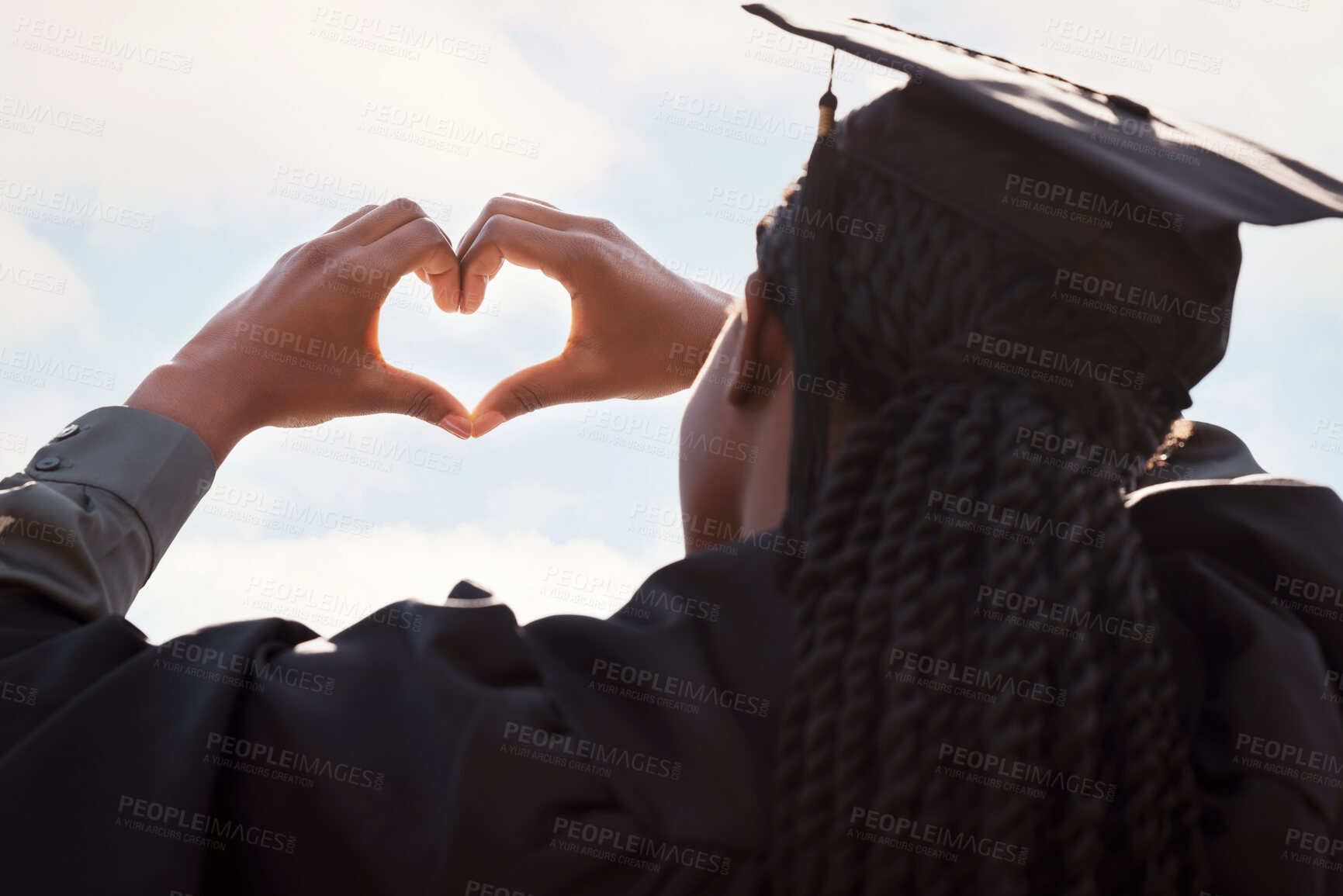 Buy stock photo Black girl, sign and heart hands with blue sky on graduation for education love, achievement and celebration for degree. Student back, gesture and gratitude for accomplishment, graduate and outdoor.