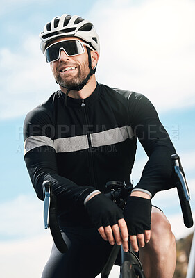 Buy stock photo Cropped shot of a handsome mature man taking a break while cycling outdoors