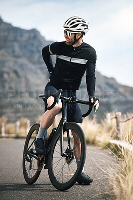 Buy stock photo Full length shot of a handsome mature man taking a break while cycling outdoors