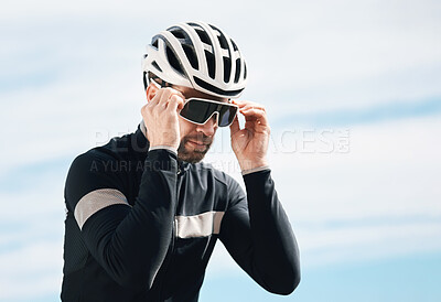 Buy stock photo Cropped shot of a handsome mature man taking a break while cycling outdoors