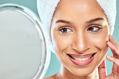 Buy stock photo Shot of a beautiful young woman admiring herself in the mirror against a studio background