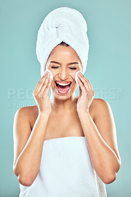 Buy stock photo Laugh, towel and woman for skincare or cleansing, cotton pads and pamper for blue background. Cosmetology, smile or hygiene routine for spot control, retinol or hyaluronic acid for female person