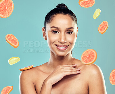 Buy stock photo Shot of a beautiful young woman posing with fruit against a studio background