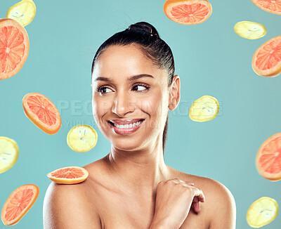 Buy stock photo Shot of a beautiful young woman posing with fruit against a studio background