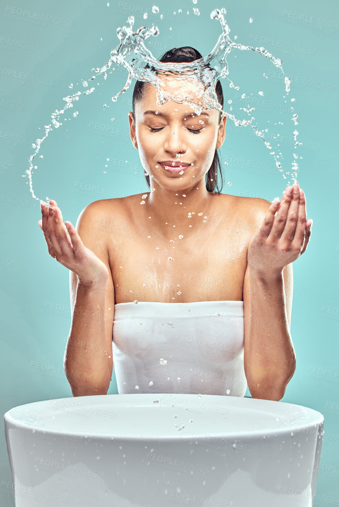 Buy stock photo Sink, woman and water splash in studio for hygiene, cleaning and cosmetics for skincare. Model girl, washing face and wellness for morning, facial and dermatology for  glow by blue background 