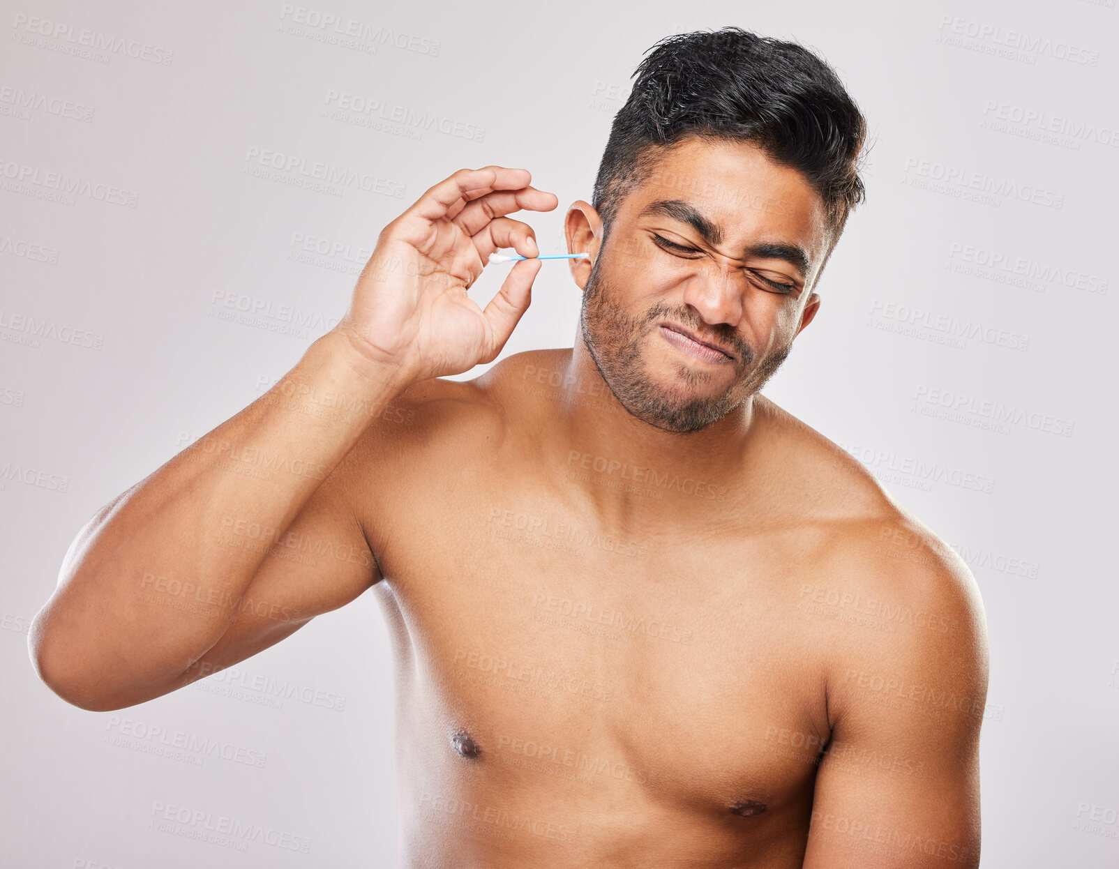 Buy stock photo Man, hygiene or cleaning ear with bud in studio  white background for model, freshness and cosmetics. Male person, topless and grooming with cotton for self care, wax removal and wellness or comfort