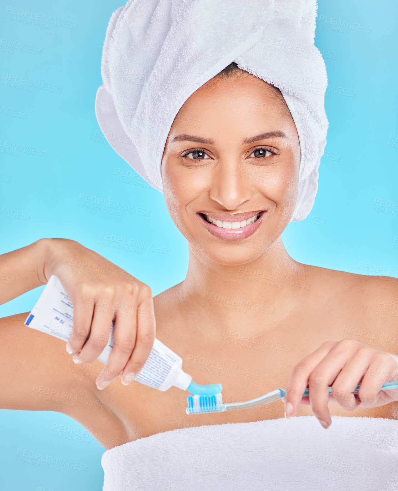 Buy stock photo Portrait, studio or happy woman brushing teeth with dental toothpaste for healthy oral hygiene. Product, morning or face of girl cleaning mouth with brush for smile or wellness on blue background