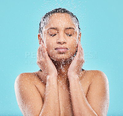 Buy stock photo Cleaning, shower and woman in studio for skincare, hygiene or wellness isolated on blue background. Water, face and model bath with eyes closed for dermatology, health and wash for beauty treatment