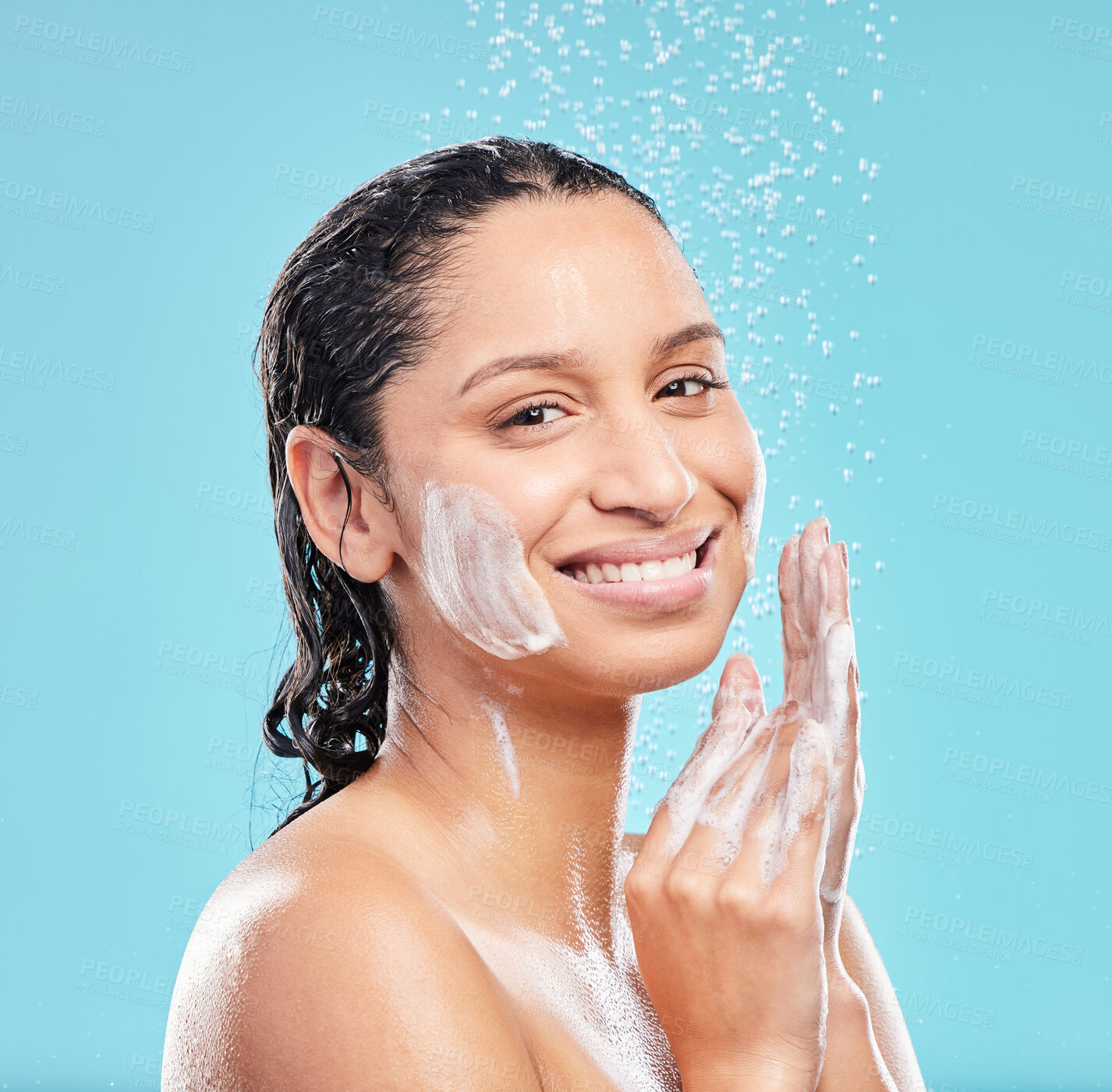 Buy stock photo Shower, cleaning and portrait of happy woman for skincare, hygiene or wellness isolated on blue studio background. Water splash, soap bath and face of model for dermatology, health or wash for beauty