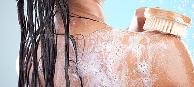 Buy stock photo Shot of an unrecognizable woman showering against a blue background