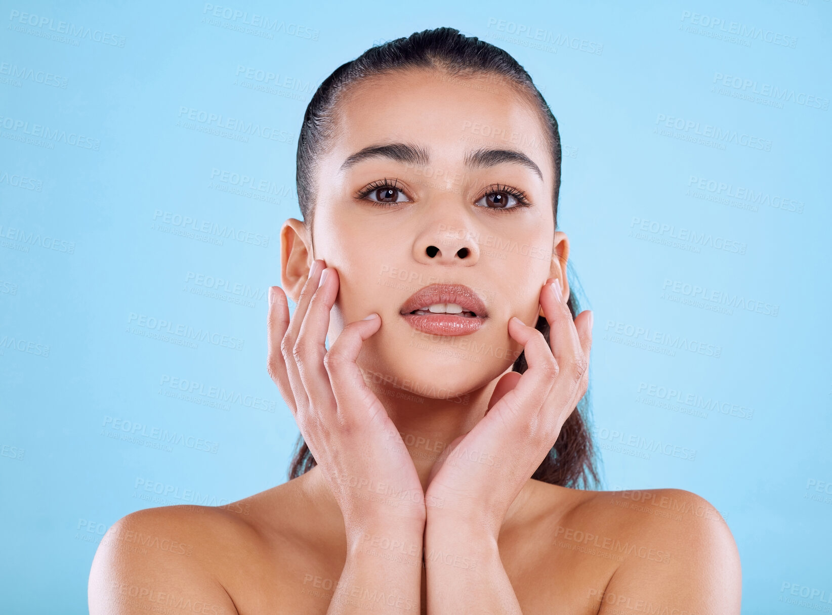 Buy stock photo Studio, skincare and portrait of woman with hands, facial cosmetics and natural makeup for healthy glow. Beauty, dermatology and face of girl with confidence, wellness and care on blue background.