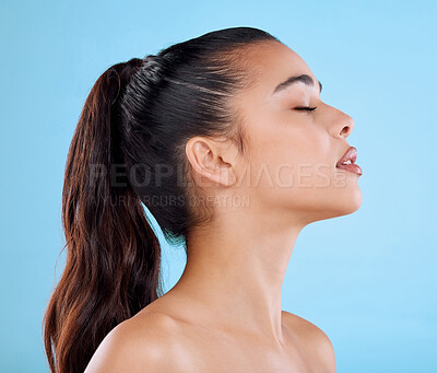 Buy stock photo Studio, relax and profile of woman with skincare, cosmetics and natural makeup for healthy glow. Beauty, dermatology and calm face of girl with confidence, wellness and thinking on blue background.