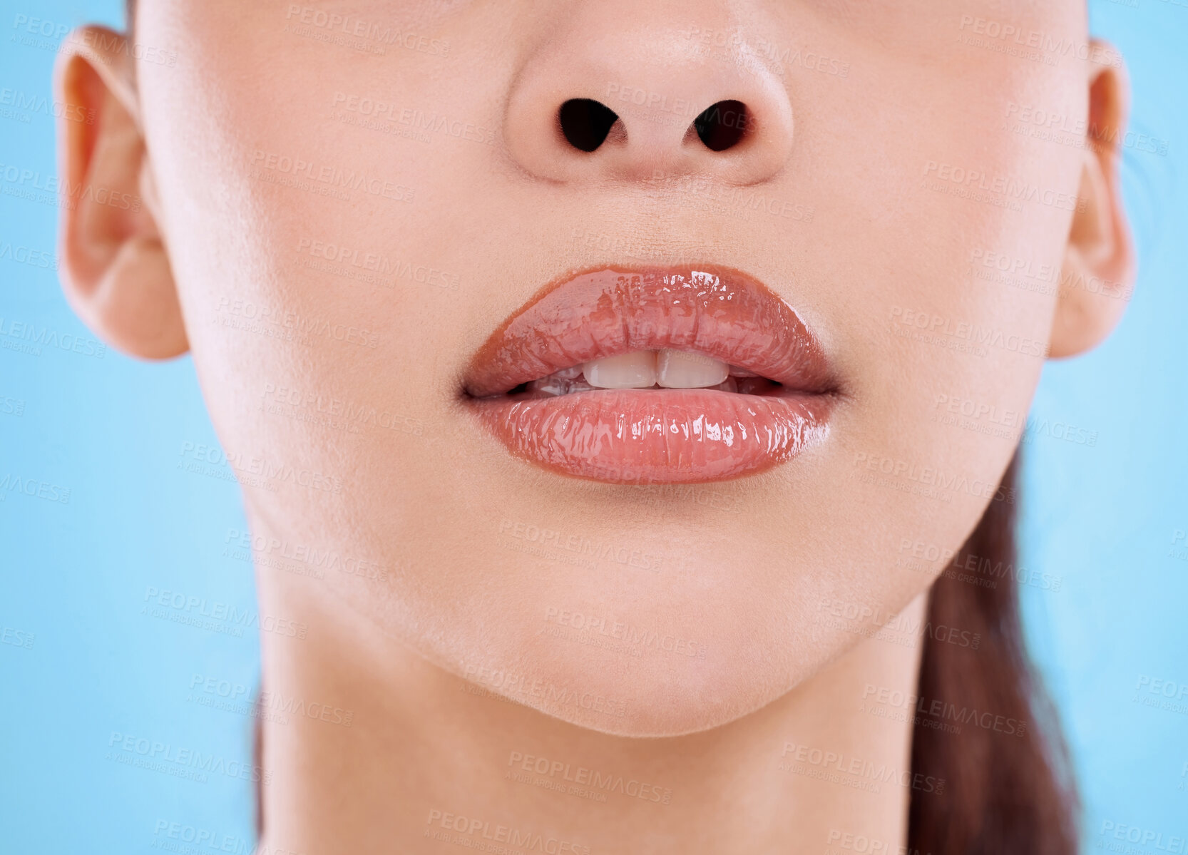 Buy stock photo Studio shot of an unrecognizable young woman posing against a blue background