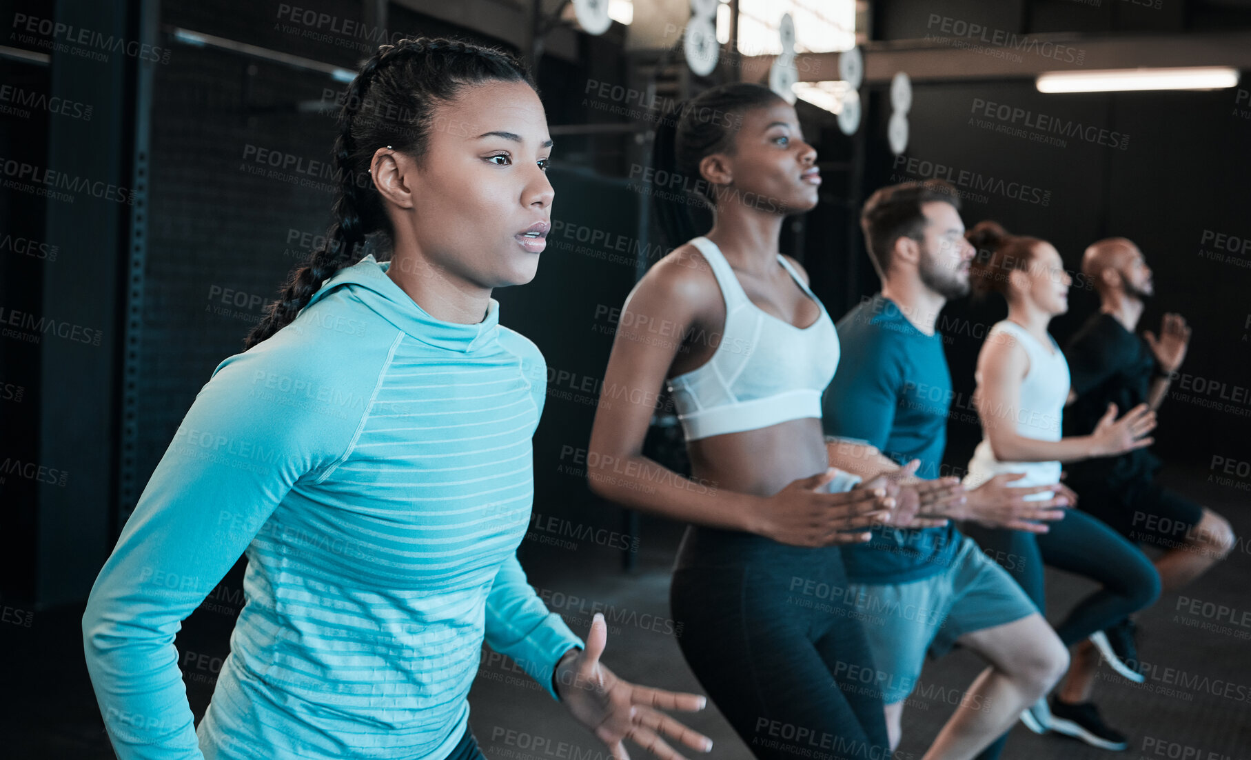 Buy stock photo Shot of a group of people jogging together at the gym