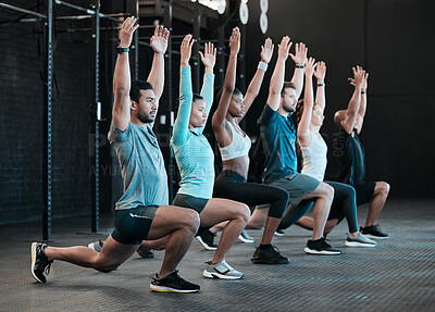 Buy stock photo Shot of a group of people doing lunges together at the gym