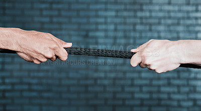 Buy stock photo Shot of two people pulling a rope in tug of war at the gym