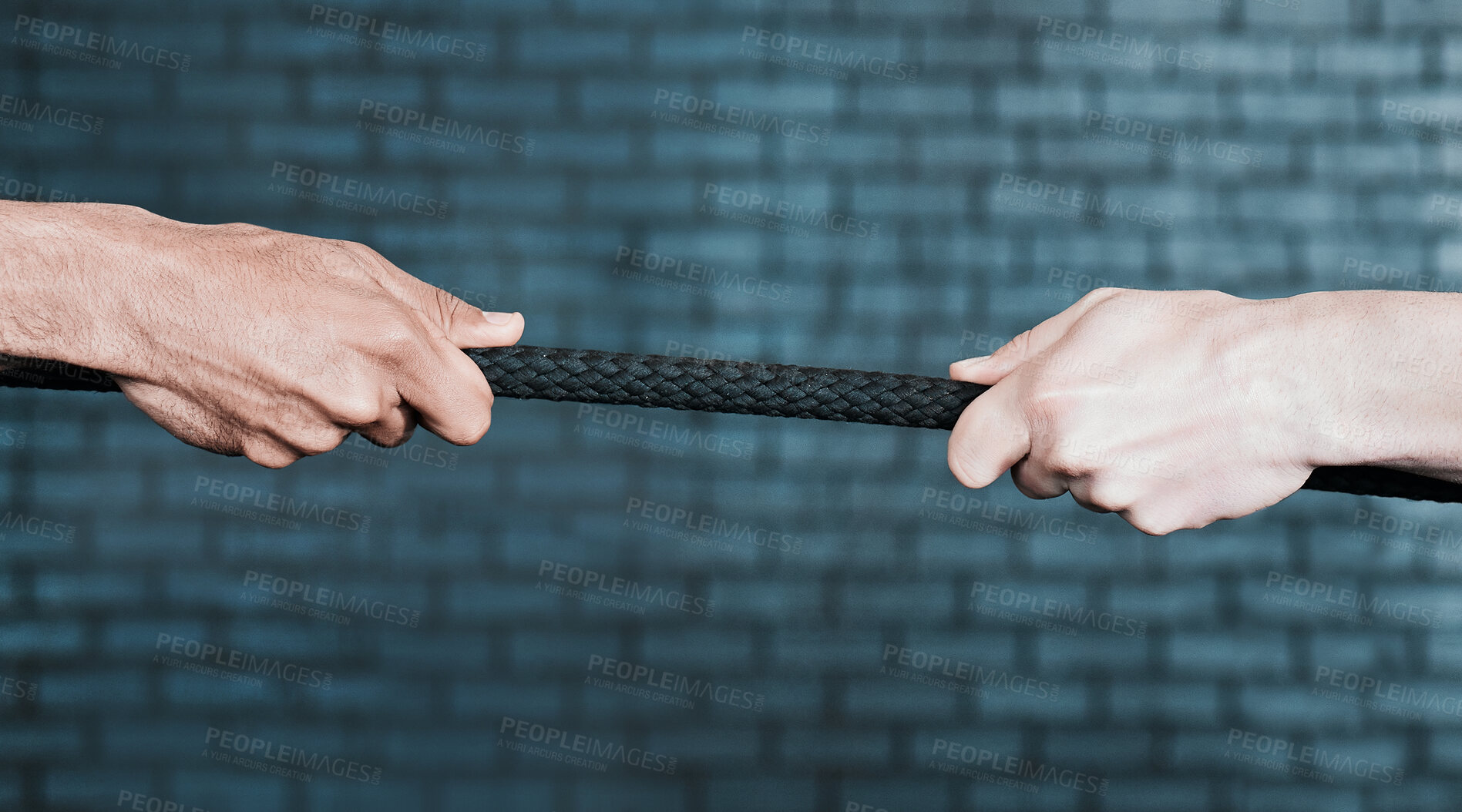 Buy stock photo Shot of two people pulling a rope in tug of war at the gym
