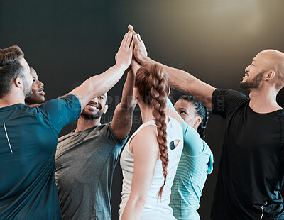 Buy stock photo Shot of a group of friends high fiving one another at the gym