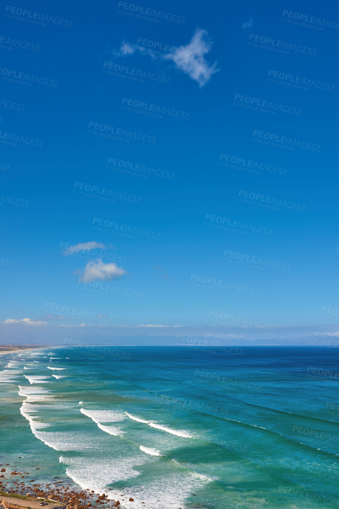 Buy stock photo Beautiful and relaxing view of ocean, beach and a cloudy blue sky with copy space background. Landscape of calm and remote sea with waves rolling onto the shore in natural environment on a sunny day