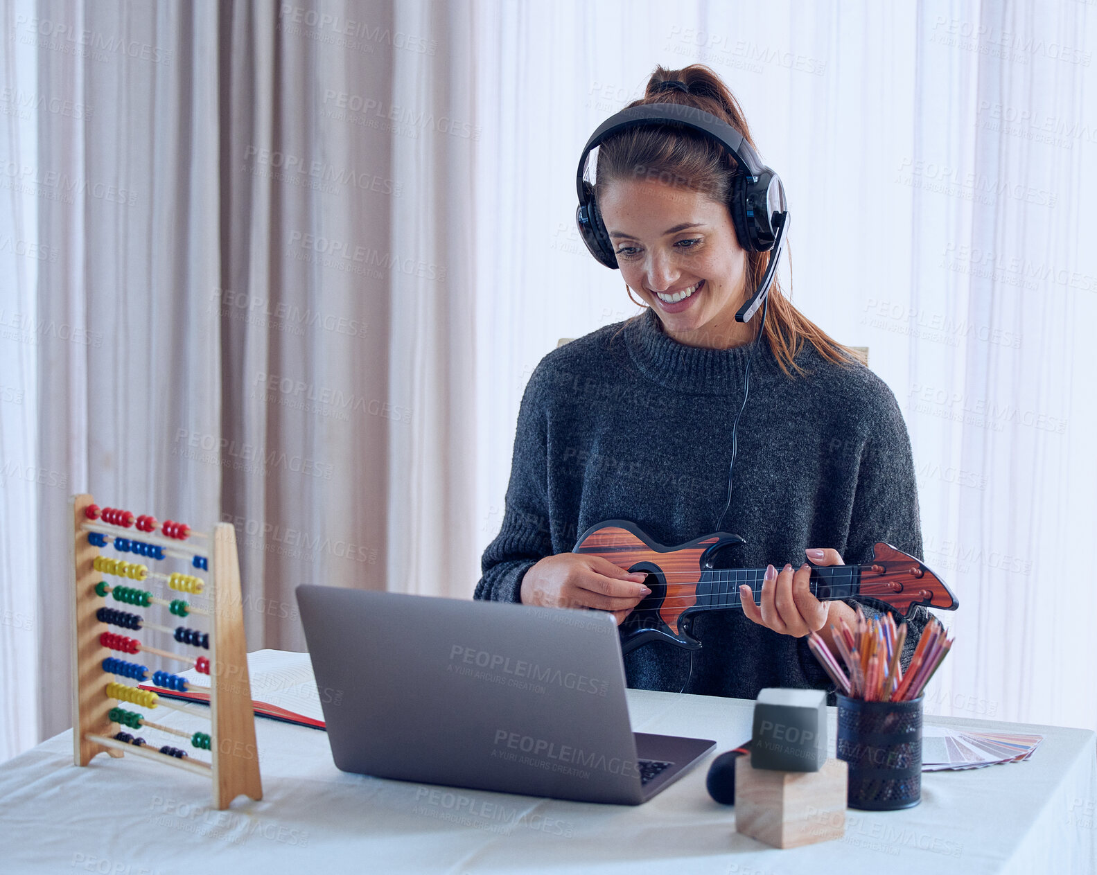 Buy stock photo Shot of a young teaching an online lesson with her laptop at home