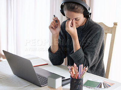 Buy stock photo Shot of a young getting a headache while teaching an online lesson with her laptop at home