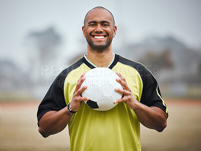 Buy stock photo Cropped portrait of a handsome young male soccer player standing outside