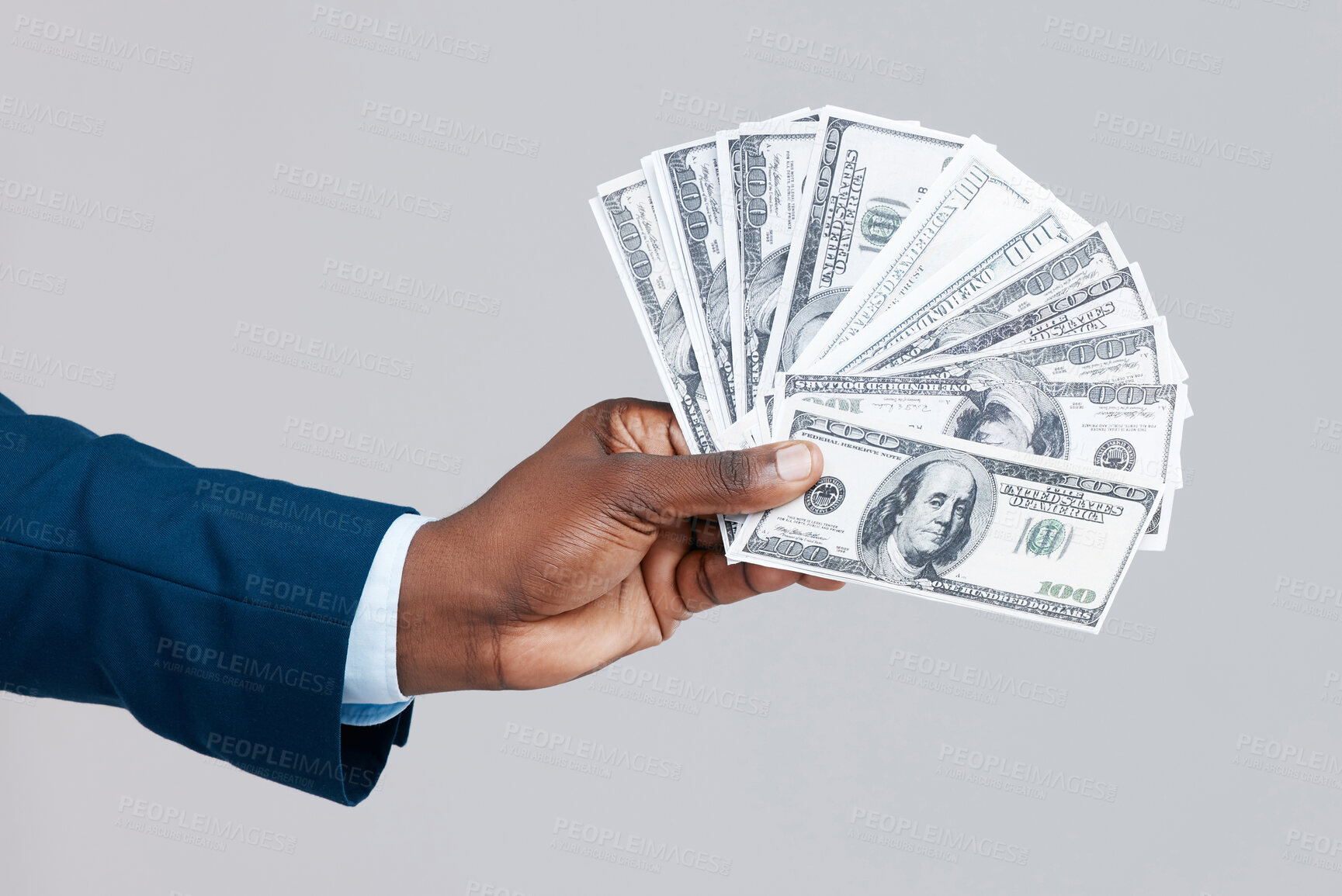 Buy stock photo Studio shot of an unrecognisable businessman showing off US dollars against a grey background