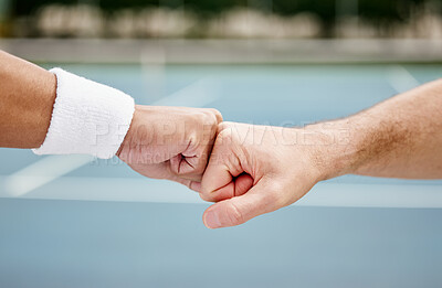 Buy stock photo Cropped shot of two unrecognizable tennis players fist bumping while standing outside on a court