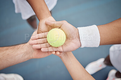 Buy stock photo High angle shot of four unrecognizable tennis players standing in a huddle with a ball on the court