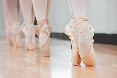 Buy stock photo Shot of a group of ballerina dancers practicing a routine in their pointe shoes